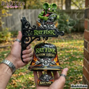 Close up of the Rat Fink commemorative wall bell on a brick wall.